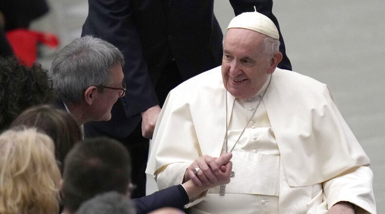 Italian CGIL Union leader Maurizio Landini, left, greets Pope Francis at the end of an audience with the CGIL Italian union members in the Paul VI Hall, at the Vatican, Monday, Dec. 19, 2022. (AP PHOTO/ALESSANDRA TARANTINO