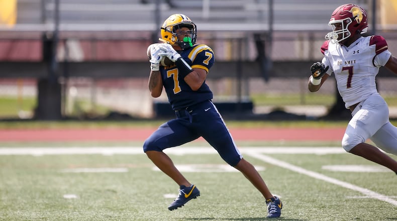Springfield High School senior Anthony Brown catches the ball in front of De Smet's Elijah Thomas during their game on Saturday afternoon at Brebeuf Jesuit Preparatory Academy in Indianapolis. Brown scored on the play as the Wildcats won 29-22. Michael Cooper/CONTRIBUTED