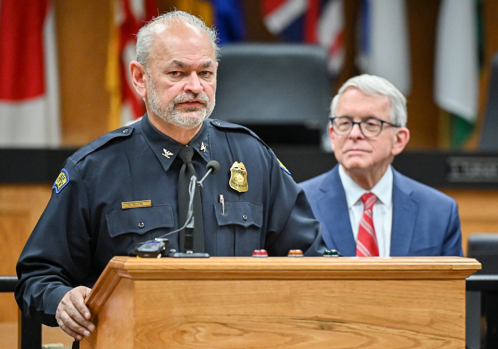 Dayton police Chief Kamran Afzal speaks while Gov. Mike DeWine listens  during a news conference on Monday, Dec. 1 at Dayton City Commission Office. Afzal said violent crime in Dayton is down about 18 percent this year. BRYANT BILLING/STAFF