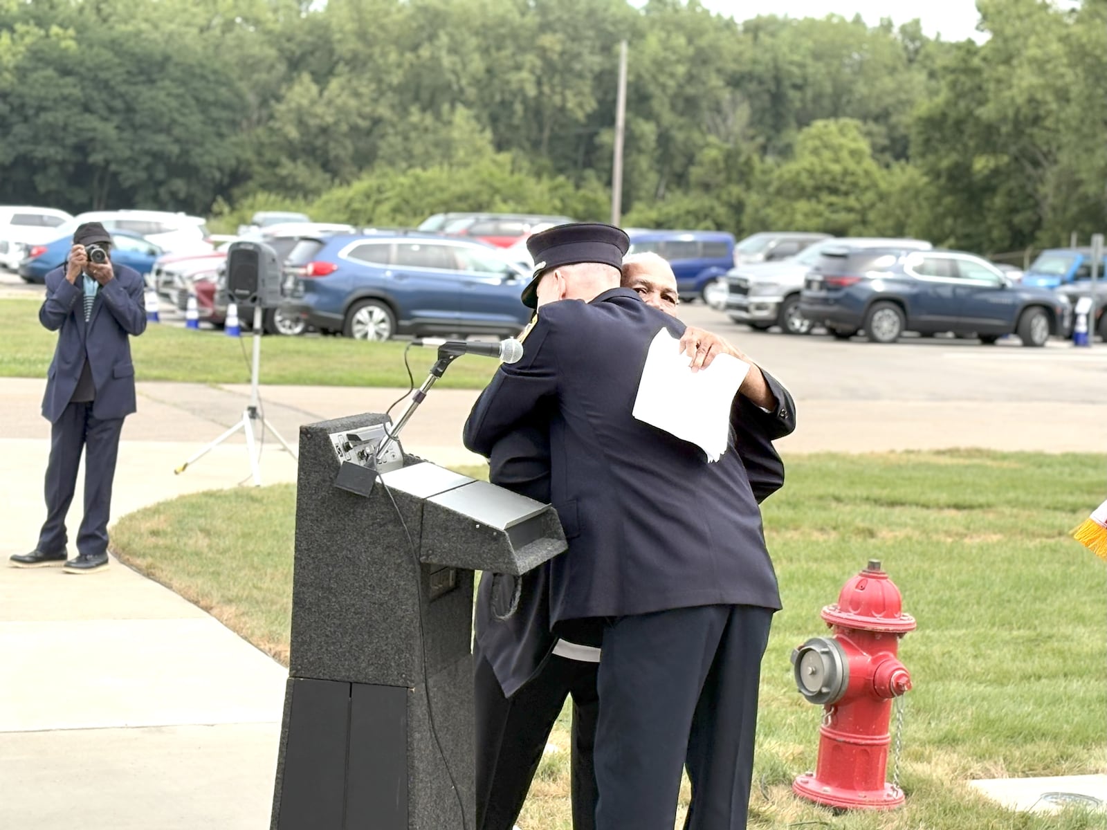 Steve Ross, Bill Ross’s son, gives Captain Steve McKee an emotional hug at the end of the dedication ceremony Saturday a Wright Patterson AFB. Ross called McKee “a fantastic person” and saud he was the person most responsible for starting the initiative to name the fire station after his father who was the first African American firefighter at WPAFB. TOM ARCHDEACON / CONTRIBUTED PHOTO