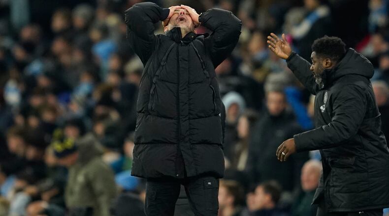 Manchester City's head coach Pep Guardiola, center, reacts after Chelsea's Enzo Fernandez scoring during the English Premier League soccer match between Manchester City and Chelsea in Manchester, England, Sunday, Jan. 4, 2026. (AP Photo/Dave Thompson)
