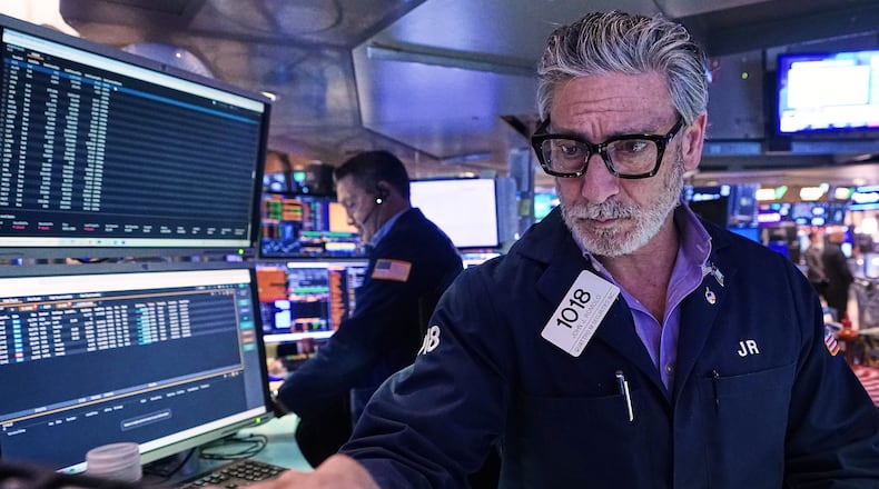 Trader John Romolo works on the floor of the New York Stock Exchange, Tuesday, Dec. 2, 2025. (AP Photo/Richard Drew)