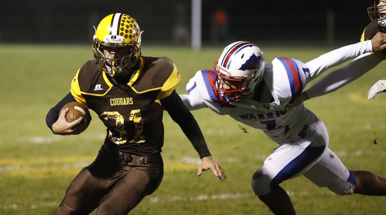 Kenton Ridge’s Carson Jones avoids a tackle by Northwestern’s Taveont Dennis-Miller. Bill lackey/Staff