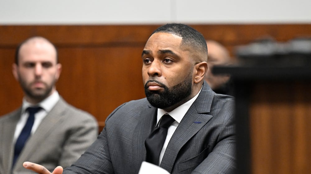 Former Michigan football coach Sherrone Moore, center, appears in the courtroom, Thursday, Jan. 22, 2026, in Ann Arbor, Mich. (AP Photo/Jose Juarez)