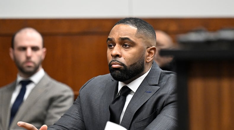 Former Michigan football coach Sherrone Moore, center, appears in the courtroom, Thursday, Jan. 22, 2026, in Ann Arbor, Mich. (AP Photo/Jose Juarez)