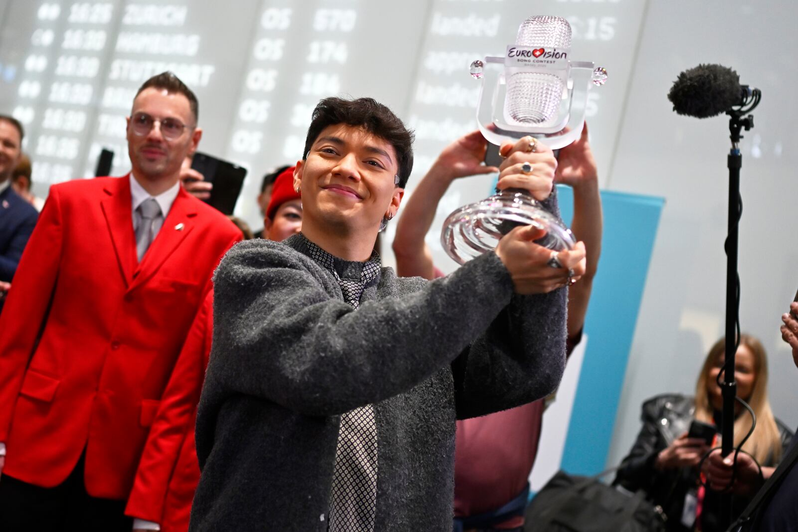 JJ, center, from Austria arrives at the airport in Vienna, Austria, Sunday, May 18, 2025, after winning the Grand Final of the 69th Eurovision Song Contest, in Basel yesterday. (AP Photo/Denes Erdos)