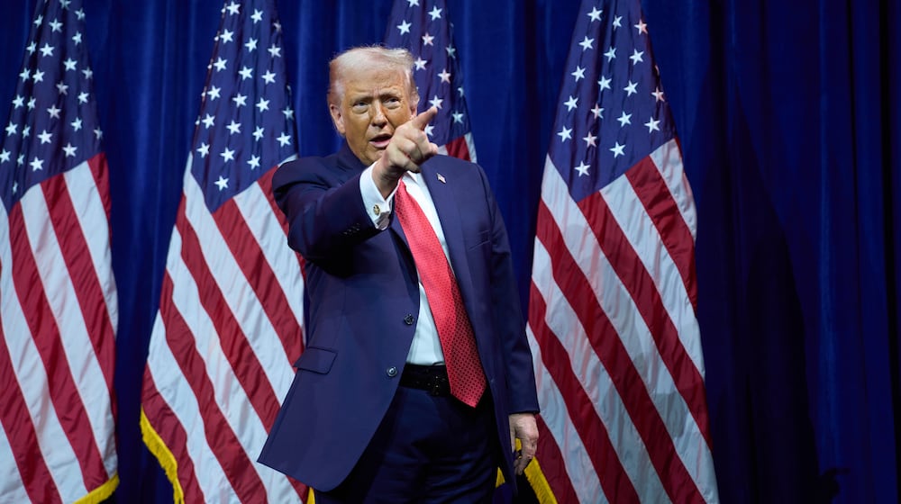 President Donald Trump points to the crowd as he walks off stage after speaking to House Republican lawmakers during their annual policy retreat, Tuesday, Jan. 6, 2026, in Washington. (AP Photo/Evan Vucci)