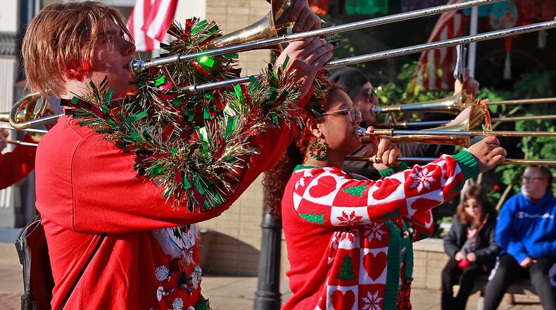 The 2022 New Carlisle Christmas Parade included the Tecumseh Band. Santa was on hand and visited with children and posed for pictures at the New Carlisle Fire Station. BILL LACKEY/STAFF