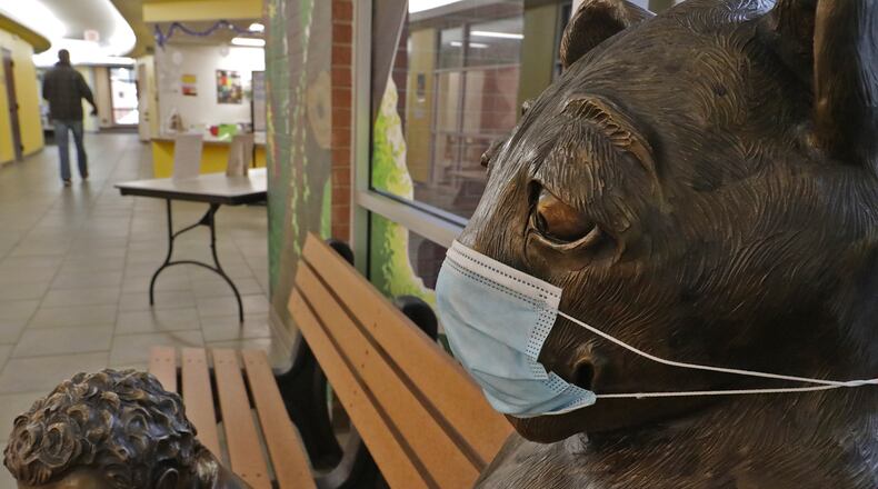 Even Leopold the Leopard, the Clark County Public Library's mascot statue, is wearing a COVID mask in the lobby of the library. BILL LACKEY/STAFF