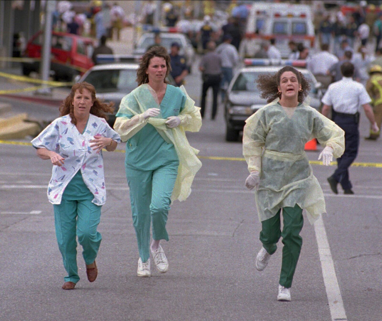 FILE - Medical assistants Janet Froehlich, Wilma Jackson and Kerri Albright run from the Alfred P. Murrah Federal Building after being told another bomb device had been found on April 19, 1995, in Oklahoma City. (AP Photo/David J. Phillip, File)