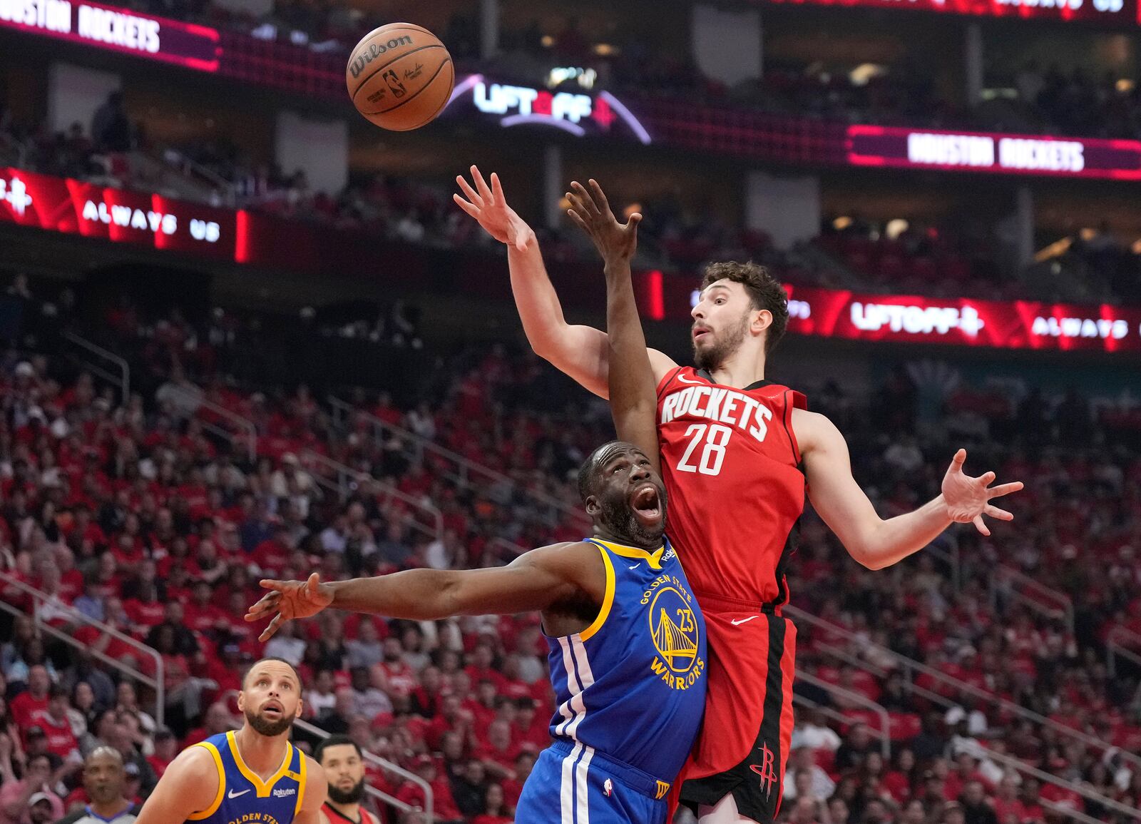 Houston Rockets center Alperen Sengun (28) shoots over Golden State Warriors forward Draymond Green (23) during the first half of Game 2 of an NBA basketball first-round playoff series against the Houston Rockets in Houston, Wednesday, April 23, 2025. (AP Photo/Karen Warren)