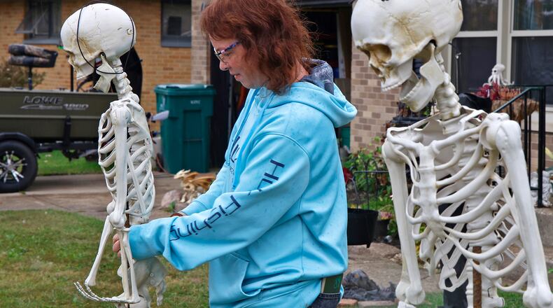 Valorie Hubbard was hanging out with some skinny friends as she sets up her Halloween display Thursday, Oct. 5, 2023 in her front yard along Tulane Road in Moorefield Township. BILL LACKEY/STAFF