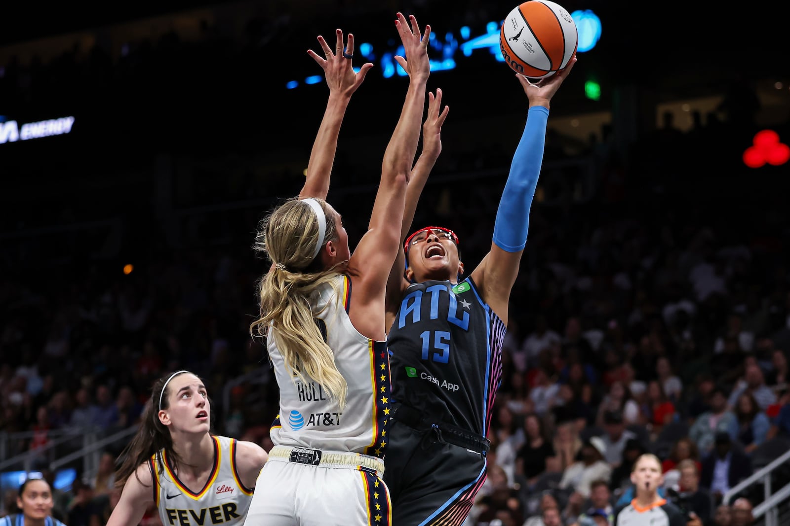 Atlanta Dream guard Allisha Gray (15) attempts a shot against Indiana Fever guard Lexie Hull, center, in the second half of an WNBA basketball game, Thursday, May, 22, 2025, in Atlanta. (AP Photo/Colin Hubbard)