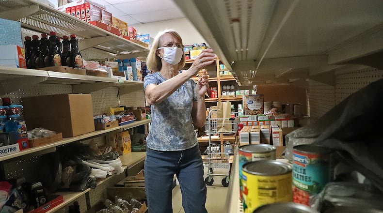 Volunteer Sherry Bostick collects items from the Enon Emergency Relief pantry for people in need in this 2020 file photo. BILL LACKEY/STAFF