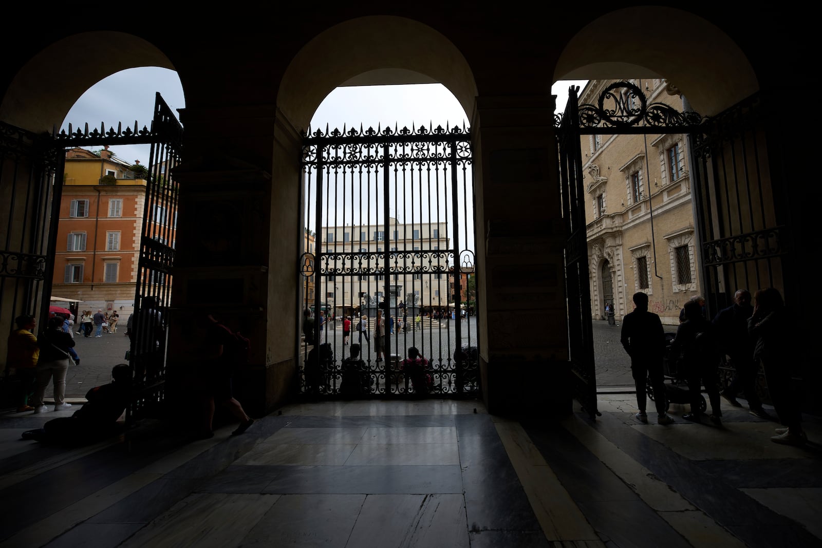 People enter Santa Maria in Trastevere church in central Rome, Sunday, May 4, 2025. (AP Photo/Alessandra Tarantino)