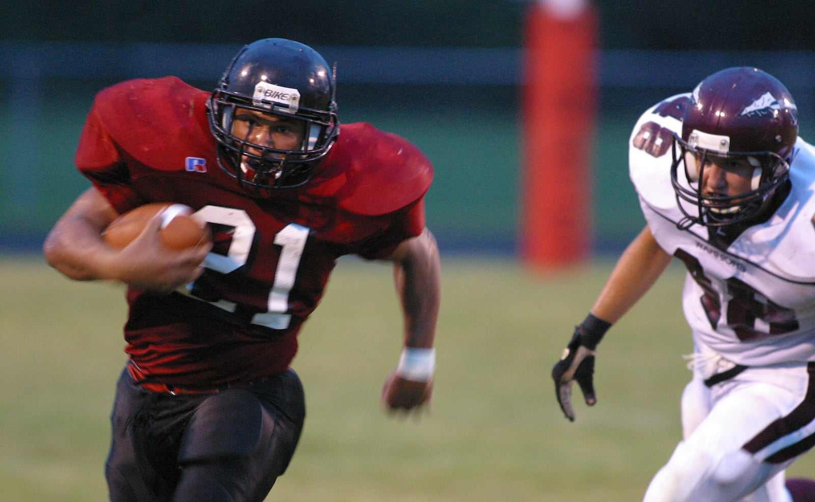 West Carrollton's Dewayne Purter moves the ball for the Pirates as Lebanon's Dillon Bomar looks for the tackle during first half action in West Carrollton. TY GREENLEES / STAFF PHOTO