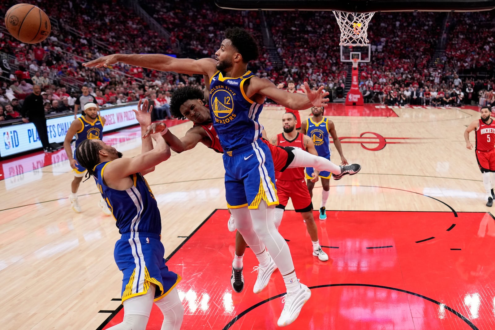 Houston Rockets forward Amen Thompson has his shot blocked by Golden State Warriors forward Braxton Key (12) during the second half of Game 5 of an NBA basketball first-round playoff series, Wednesday, April 30, 2024, in Houston. (AP Photo/David J. Phillip)
