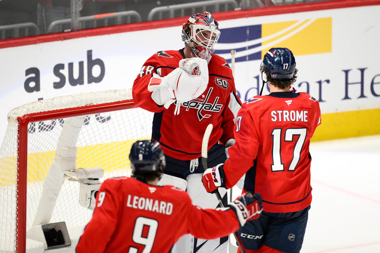 Washington Capitals goaltender Logan Thompson (48) celebrates with center Dylan Strome (17) and Ryan Leonard at the end of Game 5 of a first-round NHL hockey playoff series against the Montreal Canadiens Wednesday, April 30, 2025, in Washington. (AP Photo/Nick Wass)