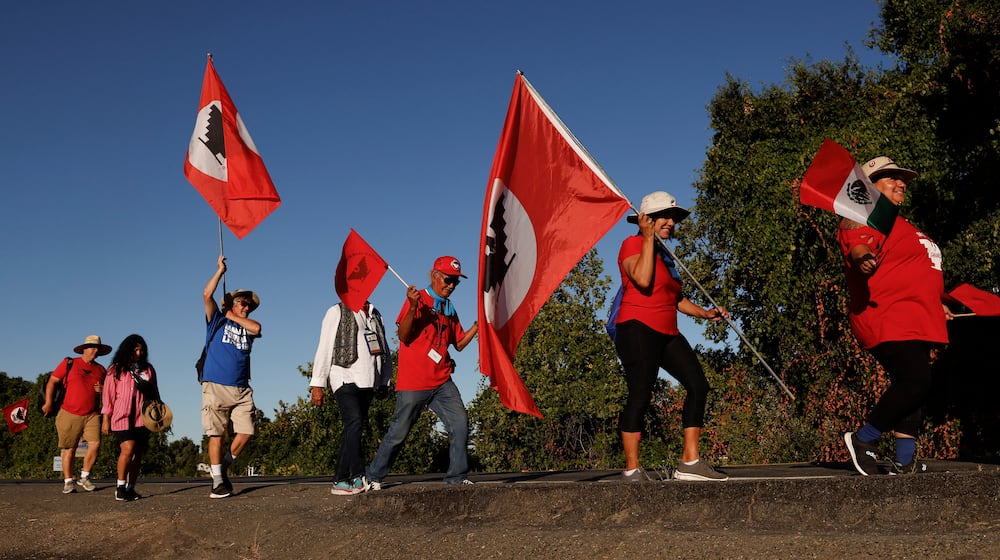 FILE - United Farm Workers members march along River Road from Walnut Grove, Calif. to Elk Grove, Calif. Wednesday, Aug. 24, 2022. (Jessica Christian /San Francisco Chronicle via AP)