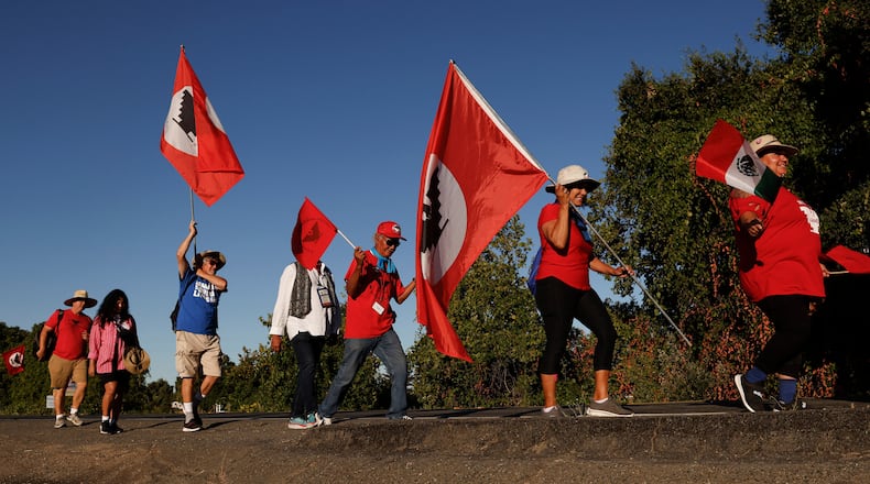 FILE - United Farm Workers members march along River Road from Walnut Grove, Calif. to Elk Grove, Calif. Wednesday, Aug. 24, 2022. (Jessica Christian /San Francisco Chronicle via AP)