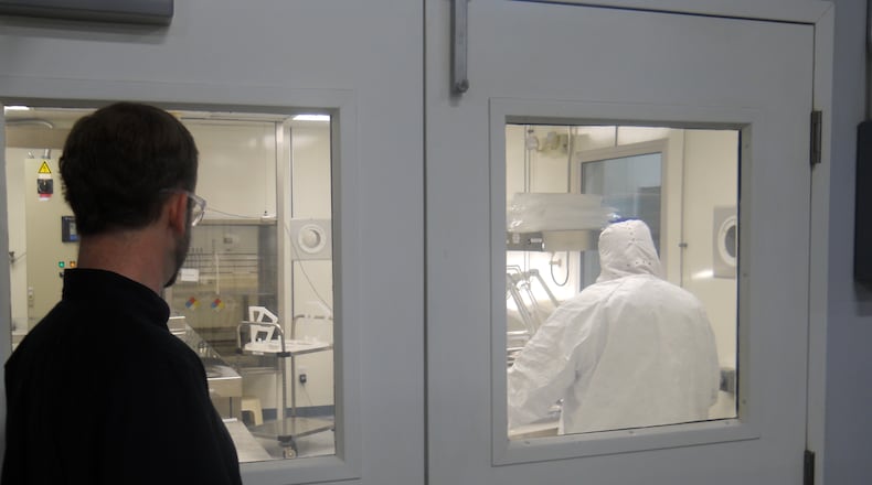 An employee at Silfex in Eaton looks in on some of the manufacturing going on. The company has purchased a property to expand to Springfield. File photo