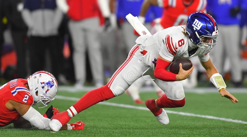 New York Giants quarterback Jaxson Dart (6) is sacked by New England Patriots linebacker Harold Landry III (2) during the second half of an NFL football game Monday, Dec. 1, 2025, in Foxborough, Mass. (AP Photo/Steven Senne)