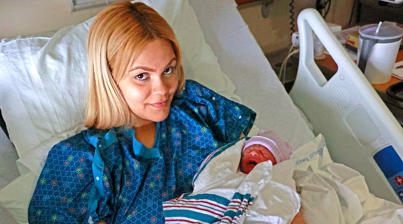 Ruth Rivas holds her new son, Ian, in the Birthing Center at Mercy Health's Springfield Regional Medical Center on Tuesday, June 20, 2023. Clark County officials say births are up at least 10% in the first part of 2023 compared to 2022, and Mercy officials said the figure could be up as much as 20%. BILL LACKEY/STAFF