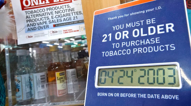 Signs on the counter at the Plum Food Mart remind customers that they have to be 21 or older to purchase tobacco or vaping products Wednesday, April 24, 2024. BILL LACKEY/STAFF