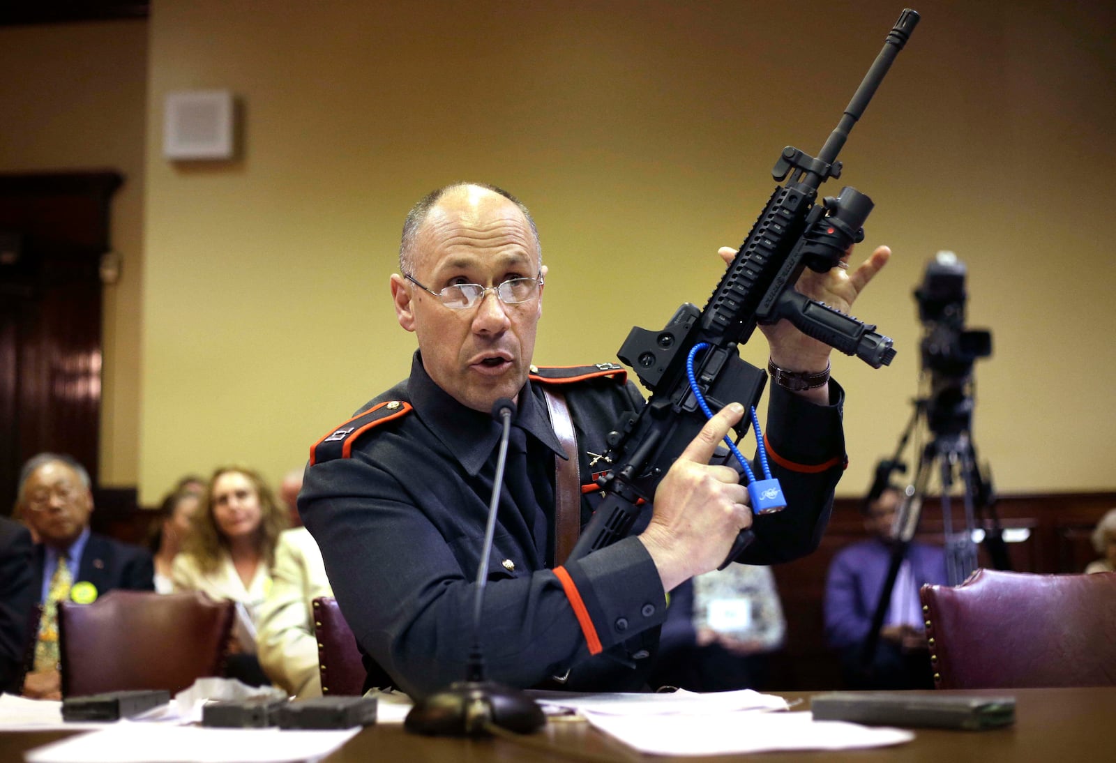 FILE - Rhode Island state police Capt. James Manni gives a demonstration using an AR-15 semi-automatic assault weapon while testifying before a R.I. House Judiciary Committee at The Statehouse, in Providence, R.I., May 1, 2013. (AP Photo/Steven Senne, File)
