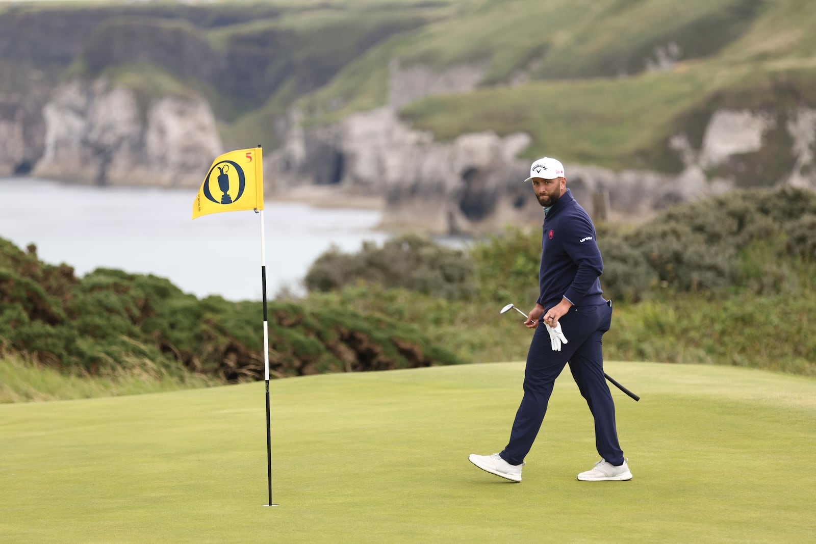 Jon Rahm of Spain looks at the lie of his putt on the 5th green during the first round of the British Open golf championship at the Royal Portrush Golf Club, Northern Ireland, Thursday, July 17, 2025. (AP Photo/Peter Morrison)