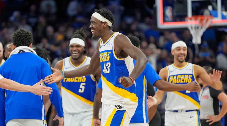 Indiana Pacers forward Pascal Siakam (43) celebrates with teammates including forward Jarace Walker (5) and guard Andrew Nembhard, right, after defeating the Orlando Magic in an NBA basketball game, Monday, March 23, 2026, in Orlando, Fla. (AP Photo/John Raoux)