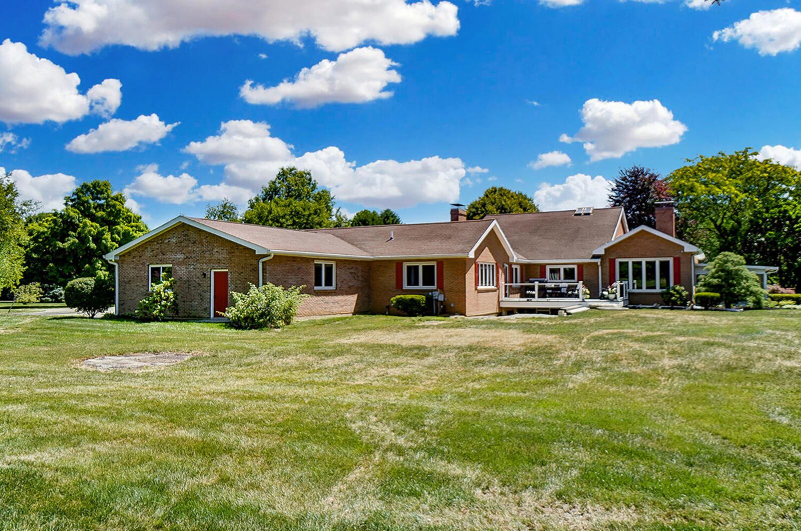 The rear of the home has a deck over the walk-out basement and a sunroom with views of the mature trees and gazebo. CONTRIBUTED PHOTO