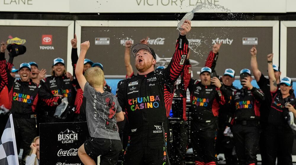 Tyler Reddick, (45) and his son Beau celebrate with the team after winning the NASCAR Daytona 500 auto race at Daytona International Speedway, Sunday, Feb. 15, 2026, in Daytona Beach, Fla. (AP Photo/Mike Stewart)
