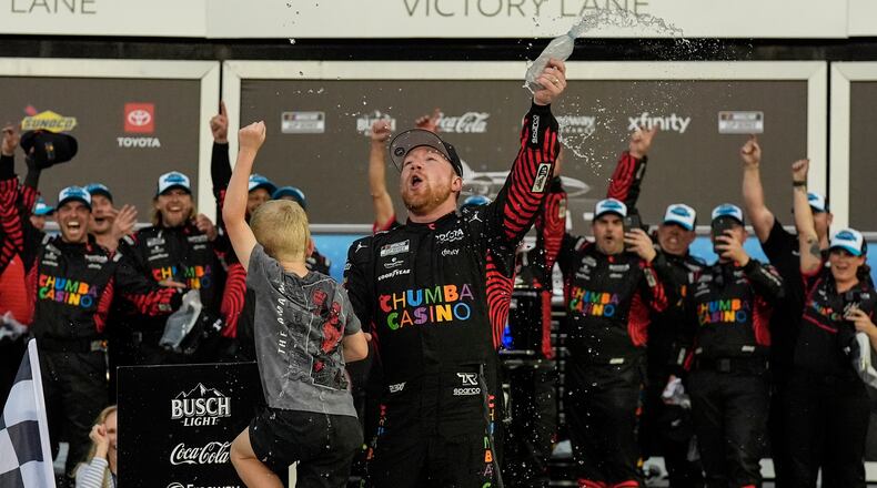 Tyler Reddick, (45) and his son Beau celebrate with the team after winning the NASCAR Daytona 500 auto race at Daytona International Speedway, Sunday, Feb. 15, 2026, in Daytona Beach, Fla. (AP Photo/Mike Stewart)