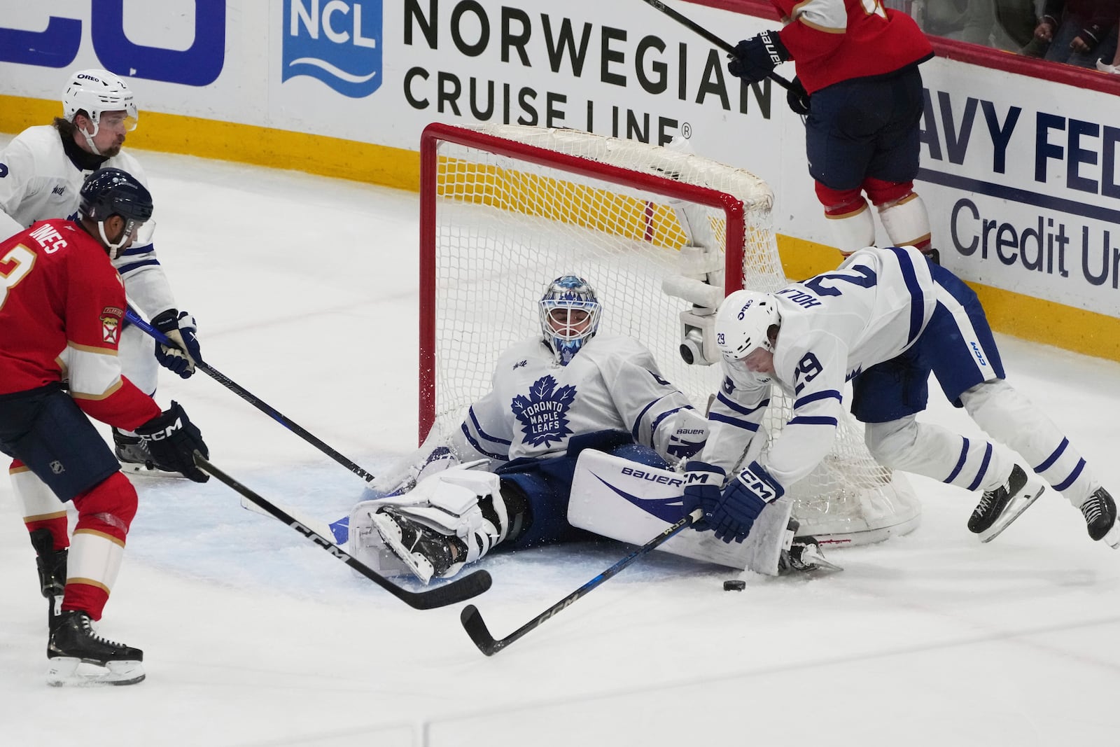 Toronto Maple Leafs goaltender Joseph Woll (60) stops a shot on goal during overtime in Game 3 of a second-round NHL hockey playoff series against the Florida Panthers, Friday, May 9, 2025, in Sunrise, Fla. (AP Photo/Marta Lavandier)
