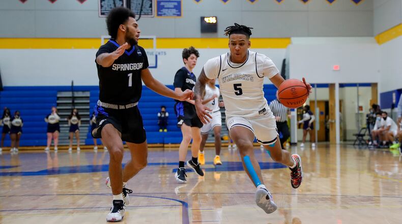Cutline: Springfield High School senior Josh Tolliver drives to the hoop against Springboro freshman Maxim Butler during their game on Friday night in Springfield. The Wildcats won 49-47. Michael Cooper/CONTRIBUTED