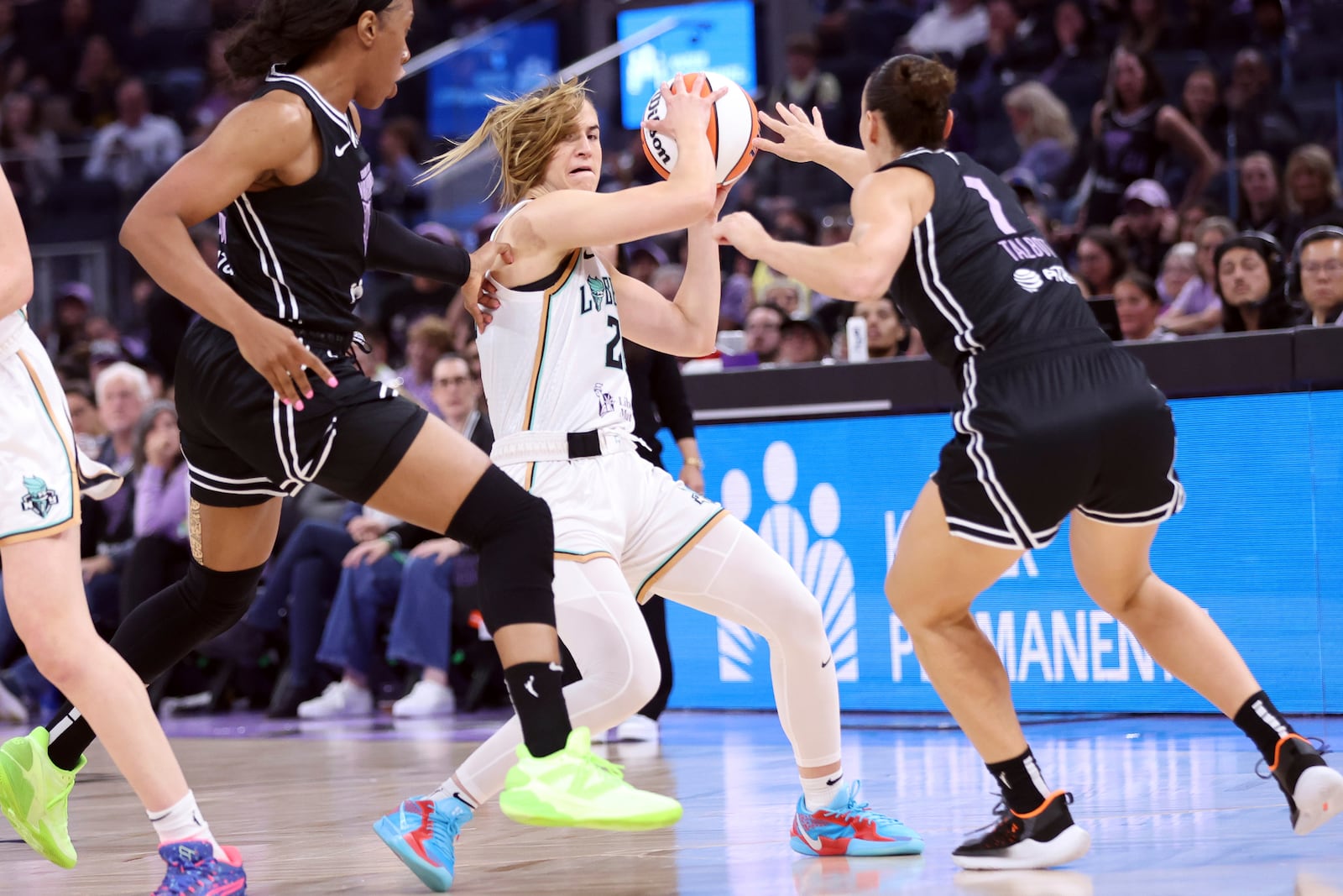 New York Liberty's Sabrina Ionescu is defended by Golden State Valkyries' Stephanie Talbot and Kayla Thornton during the first quarter of a WNBA basketball game at Chase Center in San Francisco, Wednesday, June 25, 2025. (Scott Strazzante/San Francisco Chronicle via AP)