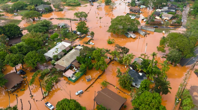 Fooding covers a residential neighborhood in Waialua, Hawaii, Friday, March 20, 2026. (AP Photo/Mengshin Lin)