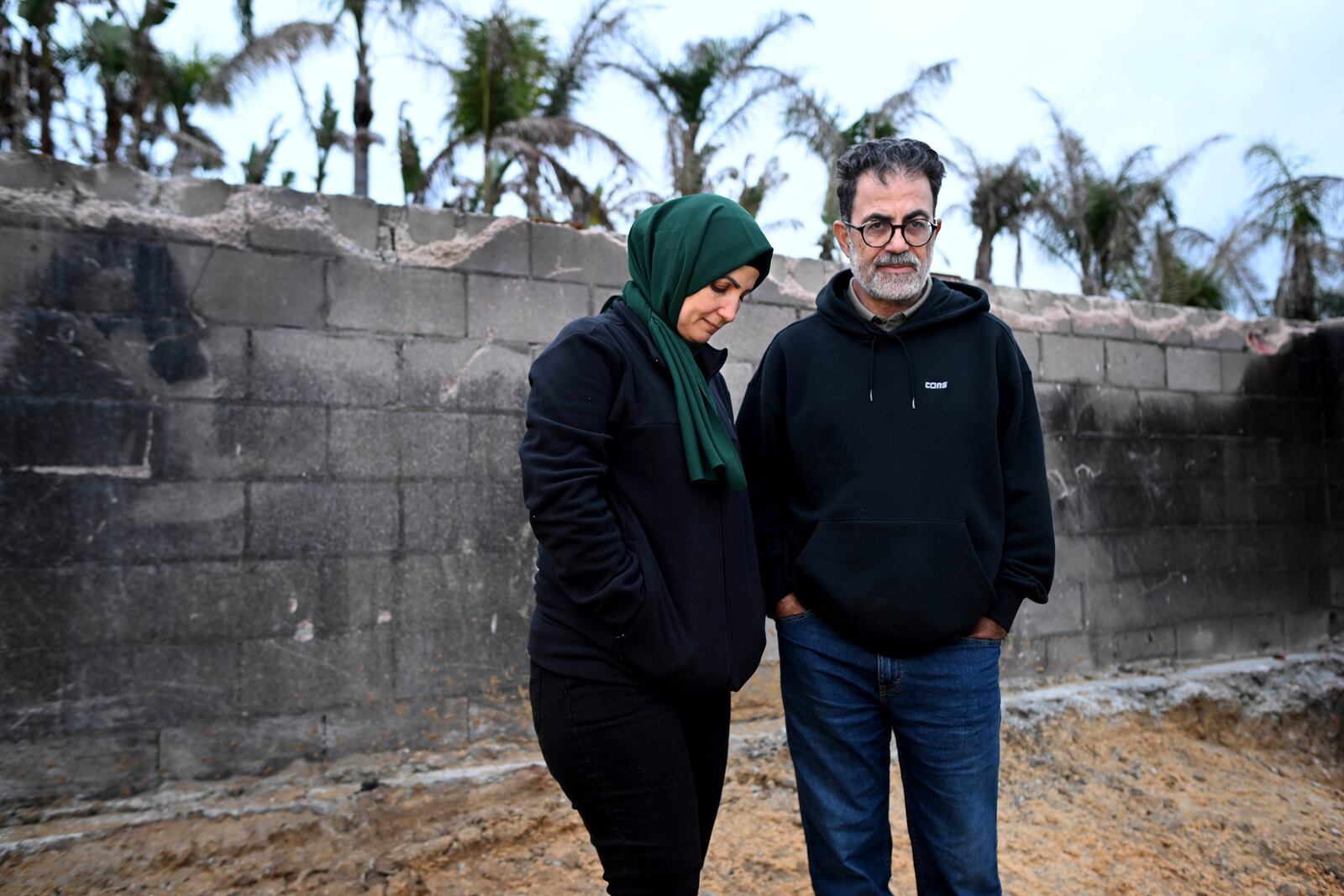 Hatim Naim and his wife Samah stand in a shell of what was their house after it burned in the Mountain Fire Wednesday, April 16, 2025, in Somis, Calif. (AP Photo/Wally Skalij)