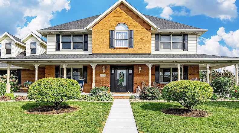 This 2-story home includes 4 bedrooms and about 2,610 sq. ft. of living space. The front features a long, covered front porch, two dormer windows and extensive landscaping with river rock. CONTRIBUTED PHOTO