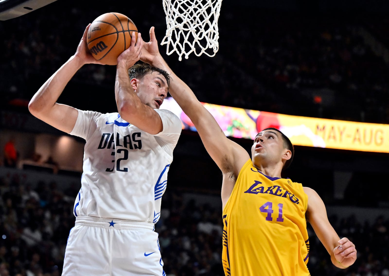 Dallas Mavericks forward Cooper Flagg (32) grabs a rebound against Los Angeles Lakers forward Cole Swider (41) during the first half of an NBA summer league basketball game Thursday, July 10, 2025, in Las Vegas. (AP Photo/David Becker)