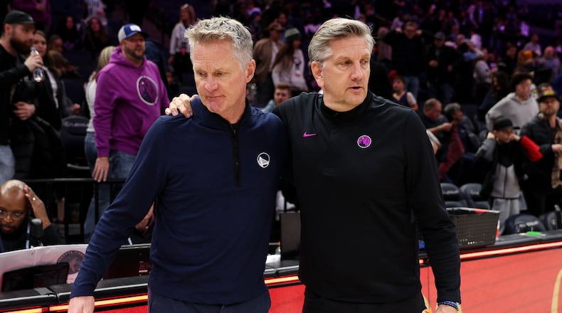 Golden State Warriors head coach Steve Kerr, left, and Minnesota Timberwolves head coach Chris Finch, right, talk after an NBA basketball game Sunday, Jan. 25, 2026, in Minneapolis. (AP Photo/Matt Krohn)