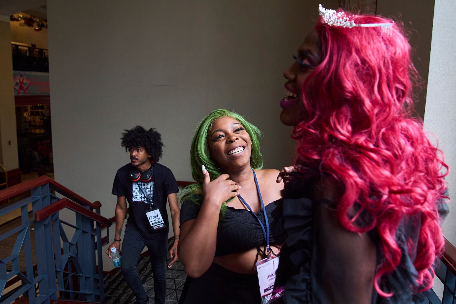 Volunteers with Capitol Pride including Alexis Brandon, center, and Camille Penelope Rose, right, who describes themself as a "Drag Entertainer," attend the opening gala of DC Black Pride, Friday, May 23, 2025, at the Capitol Hilton in Washington. (AP Photo/Jacquelyn Martin)