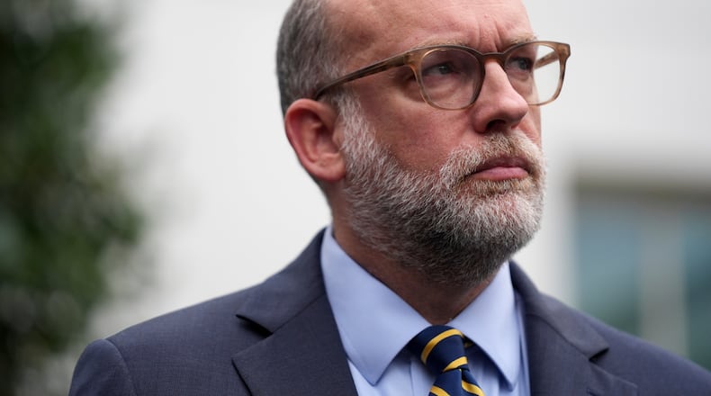 FILE - Office of Management and Budget Director Russell Vought listens to members of the media outside the West Wing at the White House in Washington, Sept. 29, 2025, in Washington. (AP Photo/Evan Vucci, File)