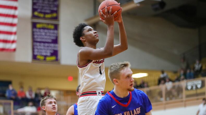 Cedarville High School senior Isaiah Ramey shoots the ball in a crowd of Tri-Village defenders during their Division IV regional semifinal game on Tuesday night at the Vandalia Butler Student Activity Center. The Indians won 67-56. Michael Cooper/CONTRIBUTED