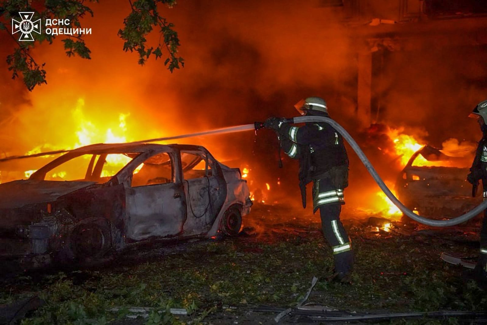 In this photo provided by the Ukrainian Emergency Service, emergency services personnel work to extinguish a fire following a Russian attack in Odesa, Ukraine, Tuesday, July 22, 2025. (Ukrainian Emergency Service via AP)