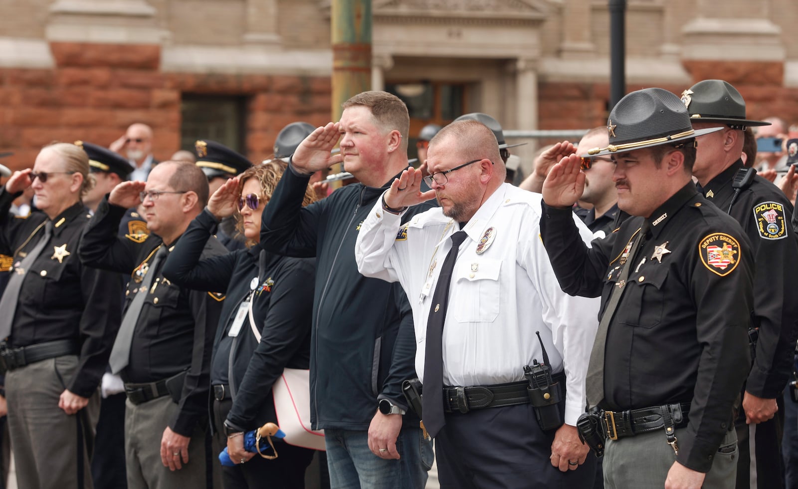 Officers pay respects during a rifle salute at Public Safety Forces Day on Friday, May 2, 2025, near the Clark County Public Safety Memorial. JOSEPH COOKE/STAFF