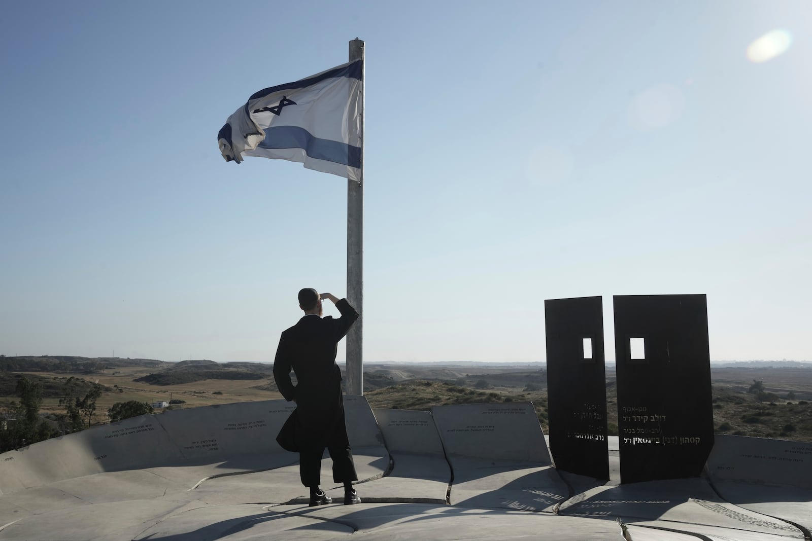 Ultra-orthodox Jewish man looks at the Gaza Strip from an observation point in Sderot, southern Israel, Monday, May 5, 2025. (AP Photo/Maya Alleruzzo)