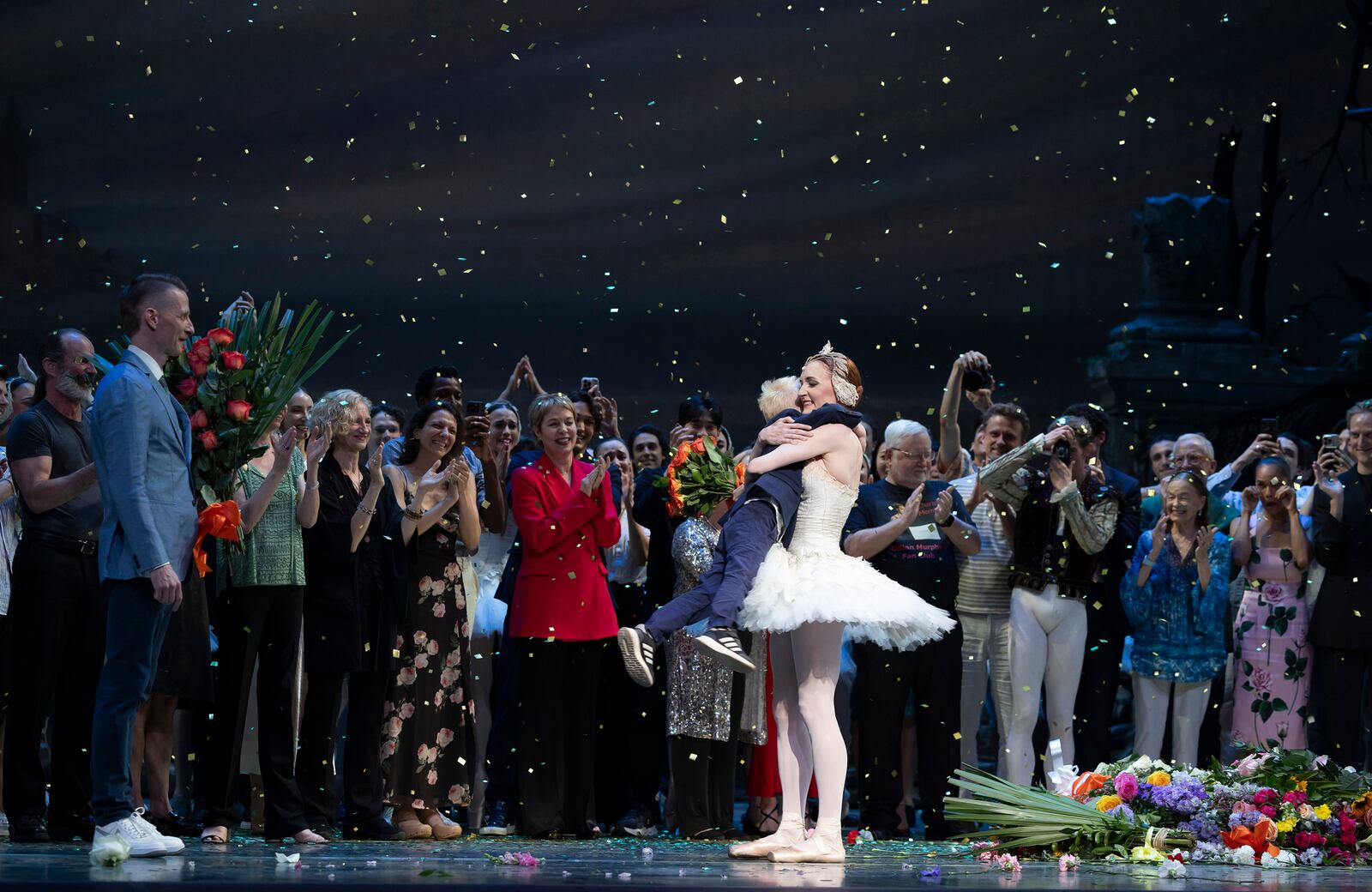 This photo provided by HELI shows Gillian Murphy with her husband Ethan Stiefel and their son Ax at the curtain call of Swan Lake, her farewell performance with American Ballet Theatre on Friday, July 18, 2025 in New York. (Rachel Papo/HELI via AP)