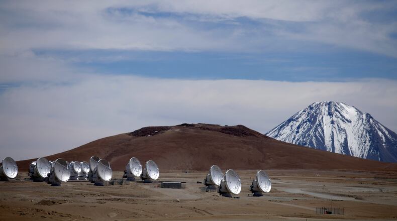 FILE - Radio antennas are spread out on the terrain as part of one of the world's largest astronomy projects, the Atacama Large Millimeter/submillimeter Array (ALMA) in Chajnator in the Atacama desert in northern Chile, Sept. 27, 2012. (AP Photo/Jorge Saenz, File)